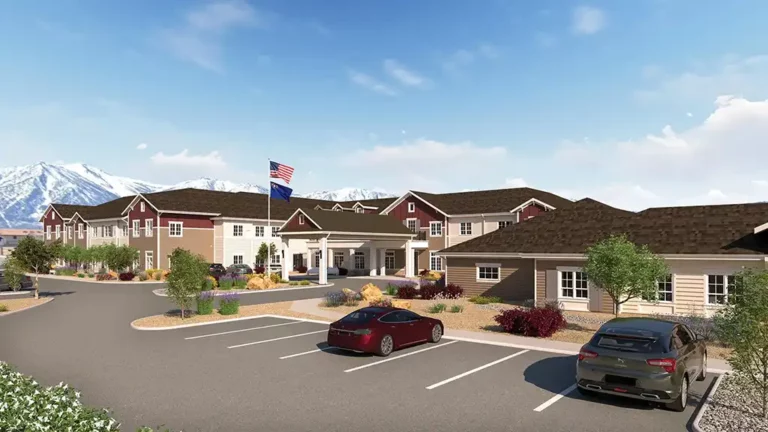 Valage Senior Living exterior view of building with snowcapped mountains mobile